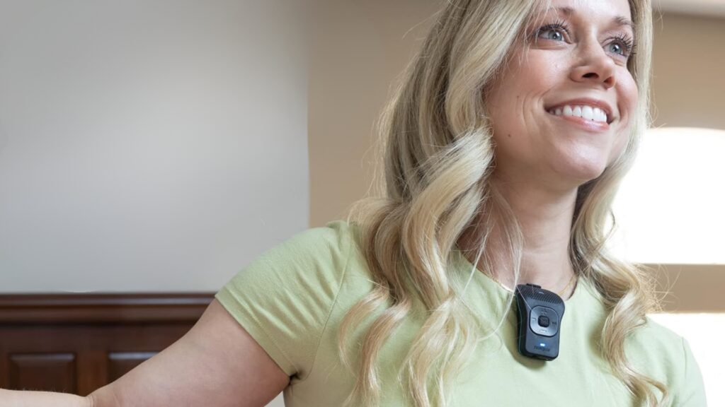 a bluetooth speaker attached to lady's clothes