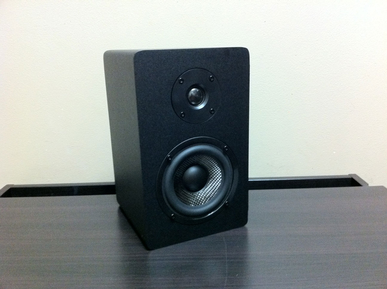 Micca MB42X Advanced Bookshelf Speakers placed on a surface