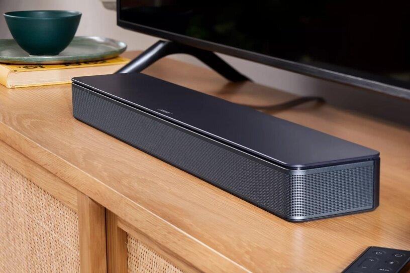 Bose TV Speaker placed on a wooden table